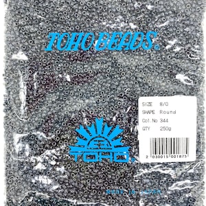 8/0 TOHO #344 Inside-Color Crystal/Dk Opaque Purple-Lined Japanese Seed Beads. 20 grams tube or factory pack.