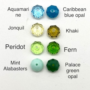 May include: Assortment of 10 faceted glass beads in various colors, including aquamarine, Caribbean blue opal, jonquil, khaki, peridot, fern, mint alabasters, and palace green opal.