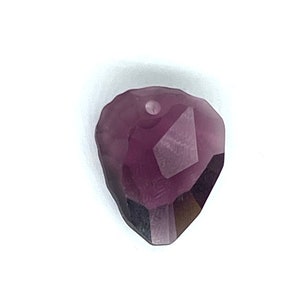 May include: A purple faceted crystal pendant with a hole at the top for stringing.
