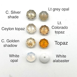 May include: Assortment of 10 round glass beads in various colors and shades, including light grey opal, ceylon topaz, c. golden shadow, topaz, white opal, and white alabaster.