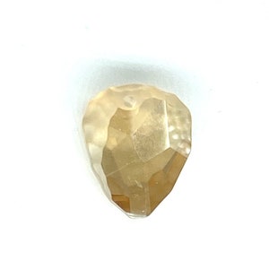 May include: A rough, faceted, light yellow diamond with a heart shape.