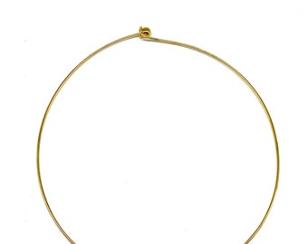 May include: A gold-toned metal choker necklace with a small ball clasp.
