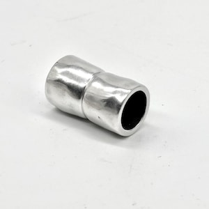 May include: A cylindrical magnetic clasp with a polished silver-tone finish and a slightly irregular, organic surface texture. The component features two interlocking sections that form a smooth, continuous tube shape when joined together.