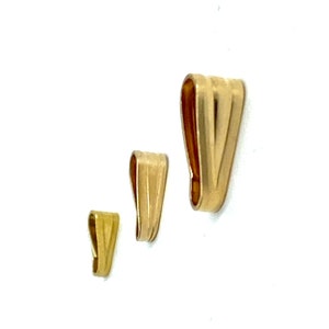 May include: Three gold-colored metal pendant bails of different sizes. The bails are shaped like a teardrop with a flat bottom and a rounded top.