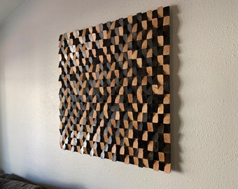 May include: A wall art piece made of wood with a geometric pattern. The wood is stained in two shades, black and brown, creating a checkered pattern.