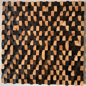 May include: A wall art piece made of wood blocks in a checkerboard pattern. The blocks are stained in two shades of brown, creating a visually interesting texture.