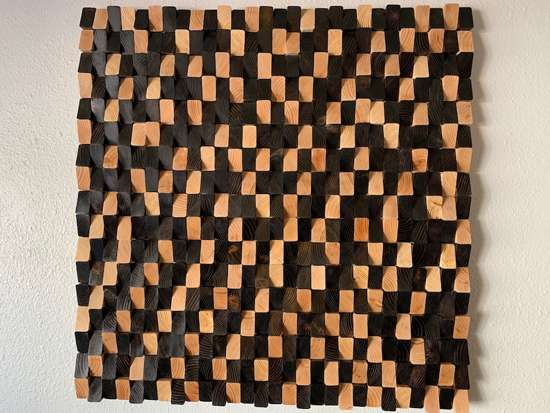 May include: A wall art piece made of wood blocks in a checkerboard pattern. The blocks are stained in two shades of brown, creating a visually interesting texture.