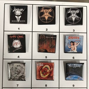 May include: A collection of 12 square metal pins featuring album covers from various heavy metal bands. The pins are arranged in a grid of four rows and three columns. The bands featured include Venom, Slayer, Exodus, Testament, and Pro-Pain.
