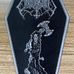 May include: Black and white embroidered patch with a coffin shape. The patch features a skull with an axe and the band name "INCANTATION" with the text "... Revenge" at the bottom.