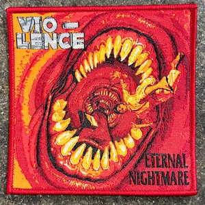 May include: A red embroidered patch with the words "VIOLENCE" and "ETERNAL NIGHTMARE" in white. The patch features a graphic of a red and yellow mouth with sharp teeth.