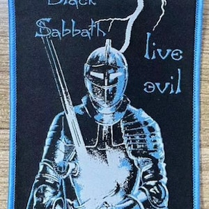 May include: Black Sabbath patch featuring a knight in blue armor holding a sword, with the words "Black Sabbath live evil" in white. The patch has a blue border and is on a black background.