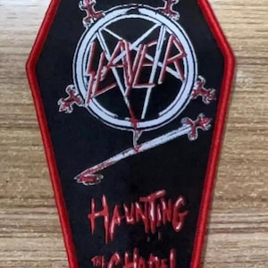 May include: Black and red embroidered patch with the Slayer logo and the text "Haunting the Chapel".