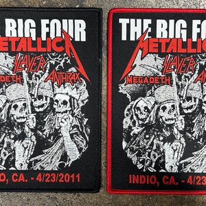 May include: Black and white patch with red text. The text reads "The Big Four Metallica Slayer Megadeth Anthrax Indio, CA. - 4/23/2011". The patch features a graphic of four skeletons.