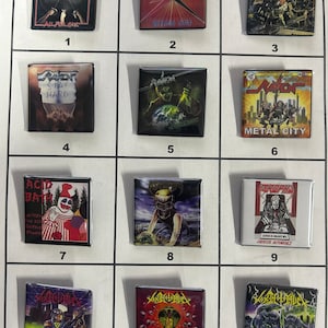 May include: A collection of 12 square metal pins featuring various heavy metal band album covers. The pins are arranged in a grid of four rows and three columns. The bands featured include:  Raven, Acid Bath, and  Acheron.