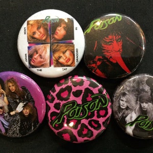 May include: Six round button pins featuring the band Poison. The pins feature a variety of images, including the band's logo, a leopard print design, and a photo of the band members. The text "Look What The Cat Dragged In" is on one of the pins.