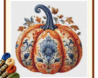May include: A cross-stitch pattern featuring a large pumpkin with a dark blue stem, decorated with intricate blue and orange floral scrollwork. The design includes scattered autumn leaves and is accompanied by several skeins of embroidery thread.