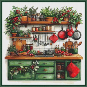 May include: A cross-stitch pattern depicting a kitchen scene with green cabinets, a wooden countertop, and shelves filled with potted plants, jars, and cooking utensils. Red oven mitts, pans, and fresh produce are arranged throughout the space.