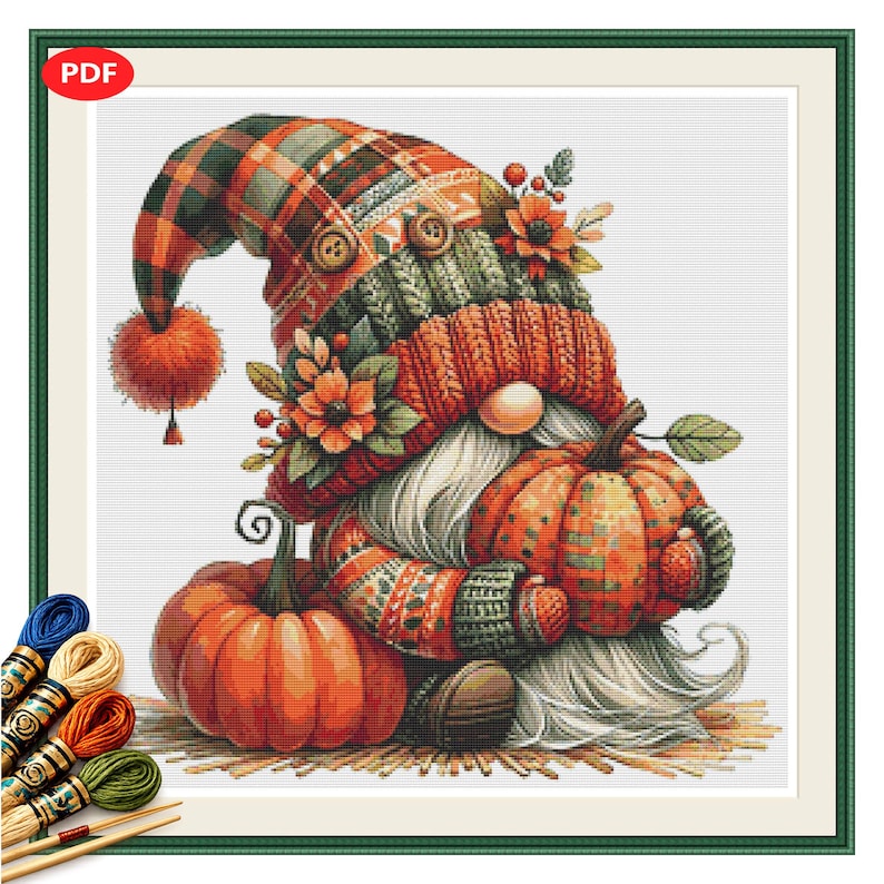 May include: A cross-stitch pattern featuring a gnome wearing a plaid hat with a pom-pom, two buttons, and floral accents. The gnome has a long white beard and holds a plaid pumpkin, with a second orange pumpkin beside it. Embroidery floss is shown.