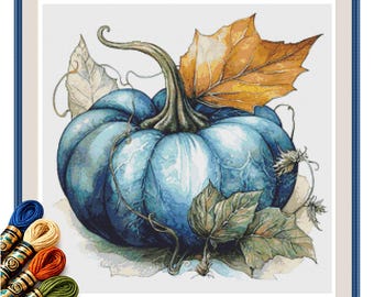 May include: A cross-stitch pattern featuring a large, vibrant blue pumpkin with a prominent stem, surrounded by detailed autumn leaves in shades of orange and green. The design includes thin, curling vines and is accompanied by several skeins of embroidery thread.
