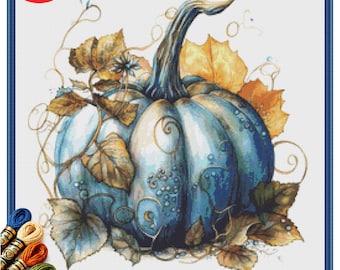 May include: A cross-stitch pattern of a blue pumpkin with a curved stem, surrounded by autumn leaves in shades of gold and brown. The design includes decorative swirls and small floral accents. The PDF icon is in the upper left corner.