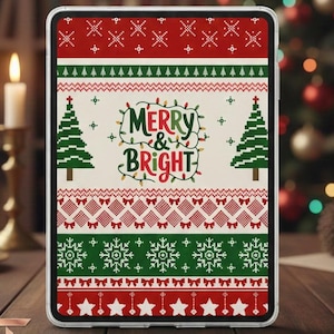 May include: A tablet case with a festive Christmas sweater design. The case features a red and green pattern with snowflakes, Christmas trees, and the words "Merry & Bright". The background includes a Christmas tree and candles.