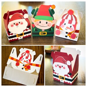 May include: Four Christmas-themed gift boxes with different designs. The boxes are made of cardboard and have a festive look. One box features a snowman, another a Santa Claus, another an elf, and the last one a Santa Claus with a beard.