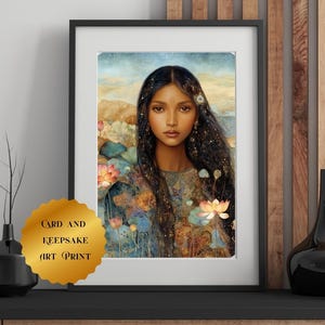 May include: Framed art print featuring a portrait of a woman with long, dark hair adorned with stars. The artwork includes lotus flowers and a soft color palette of blues, greens, and golds. The print is labeled "CARD AND KEEPSAKE ART PRINT."