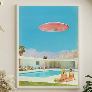 May include: A retro-style illustration of a pink flying saucer hovering over a swimming pool in a desert landscape. Two people are sitting by the pool, looking up at the saucer.