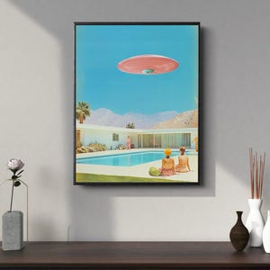 May include: A retro-style illustration of a pink flying saucer hovering over a suburban home with a swimming pool. Two people are sitting by the pool, looking up at the saucer.