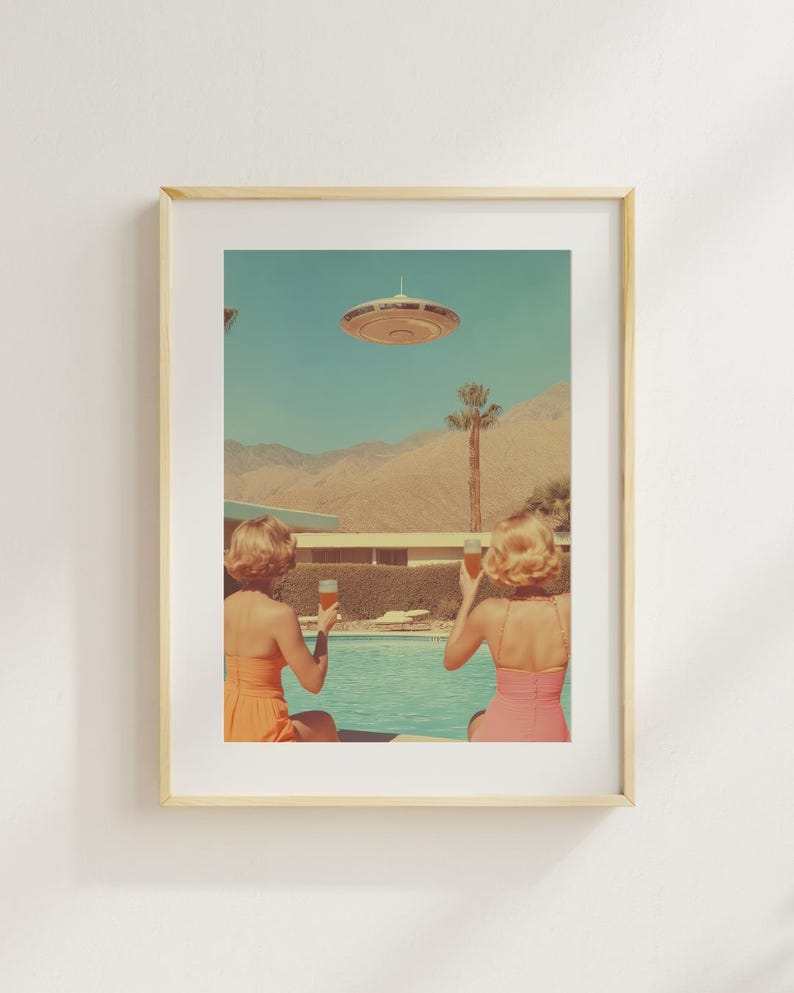 May include: Two people in swimsuits sit by a pool, looking up at a flying saucer in the sky. They are holding glasses of a light-colored beverage. The pool is surrounded by palm trees and a desert landscape.