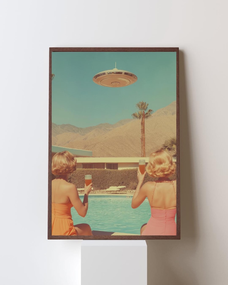 May include: Two women in swimsuits sit by a pool, raising glasses of cocktails, as a flying saucer hovers in the sky above a desert landscape.