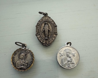 3 Women Saint Medals - Miraculous Medal, Lady of Perpetual Help, and another Miraculous Medal