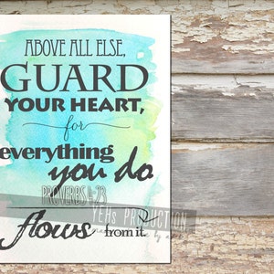May include: A watercolor print with a teal, green, and yellow background. The text reads "Above all else, guard your heart, for everything you do flows from it."  Proverbs 4:23.