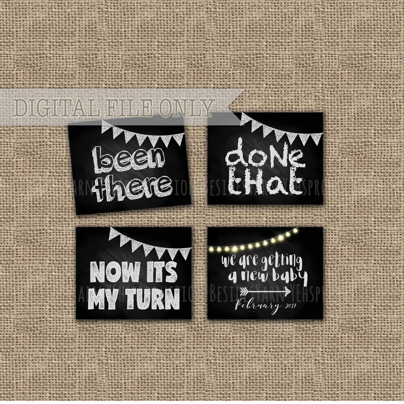 May include: Four black chalkboard signs with white text announcing a new baby. The signs read "been there", "done that", "now it's my turn", and "we are getting a new baby February 2017".