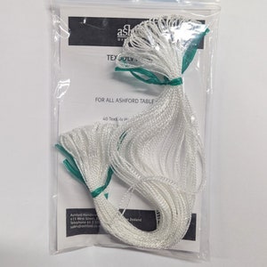 May include: A white plastic bag containing a bundle of white string, labeled "40 Texs lv H" and "FOR ALL ASHFORD TABLE". The bag is sealed with a green zipper.