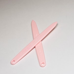 May include: Two pink nail files with the text "PREMIER" and "PAPER FILE 180/280 GRIT" printed on them.