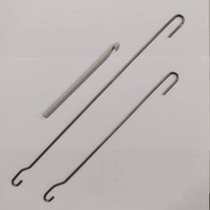 Three types of hooks offered, the plastic crochet hook, the long double ended weaving hook, and the shorter double ended weaving hook.