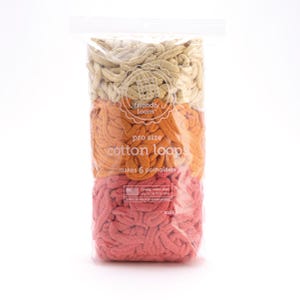 May include: A clear plastic bag filled with colorful cotton loops for making potholders. The loops are arranged in three horizontal sections of beige, orange, and coral. The bag has a label that reads "friendly loom" and "cotton loop."