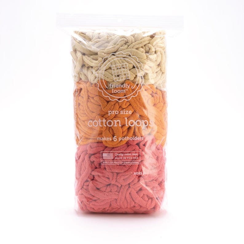 May include: A clear plastic bag filled with colorful cotton loops for making potholders. The loops are arranged in three horizontal sections of beige, orange, and coral. The bag has a label that reads "friendly loom" and "cotton loop."