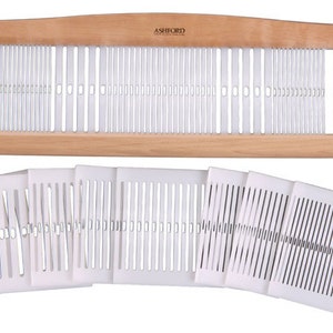 May include: A wooden Ashford table loom with a white plastic heddle and a set of eight white plastic heddles.