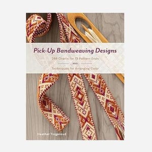 May include: A book titled Pick-Up Bandweaving Designs: 288 Charts for 13 Pattern Ends and Techniques for Arranging Color by Heather Torgenrud. The cover features a woven band with geometric patterns in orange, purple, and cream, and a wooden shuttle.