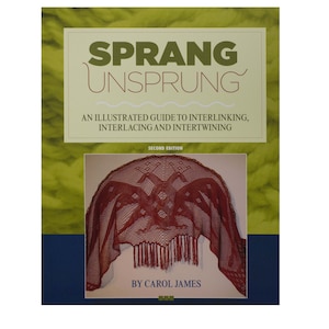 May include: Book cover with the title "SPRANG UNSPRUNG" and the subtitle "An Illustrated Guide to Interlinking, Interlacing and Intertwining". The cover features a red crocheted shawl with a fringe.