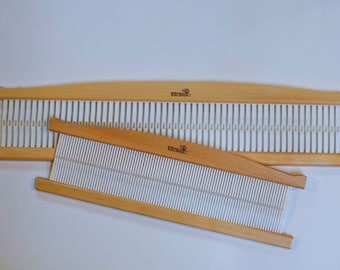 May include: Two wooden weaving looms with white stringing. The larger loom is curved and the smaller loom is straight. Both looms have the word "remarkable" printed on them.