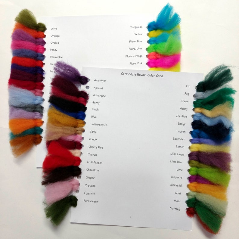 May include: A color card with wool samples in various colors, including turquoise, yellow, lime, orange, pink, amethyst, apricot, aubergine, berry, black, blue, butterscotch, camel, candy, cherry red, cherub, chili pepper, chocolate, copper, cupcake, eggplant, fern green, fir, fog, green, honey, ice blue, indigo, lagoon, lavender, lemon, lilac haze, lima bean, lime, magenta, marigold, mint, moss, and nutmeg. The card is titled "Corriedale Roving Color Card".