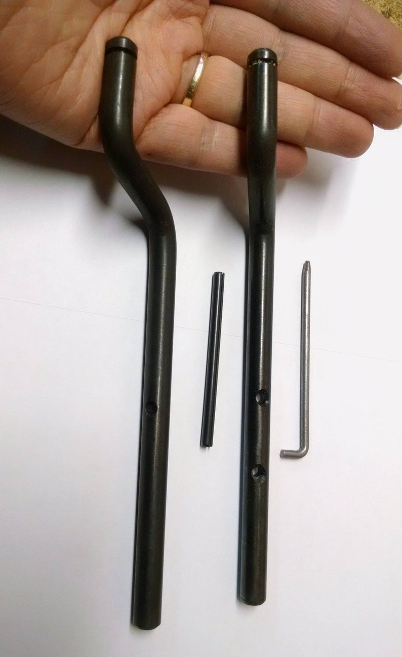 May include: Two black metal rods with a curved end and two holes. A small black metal rod and a silver metal rod with a bent end are also included.
