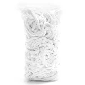 May include: A white plastic bag filled with white, fluffy, string-like material. The material is tightly packed and appears to be soft and flexible.