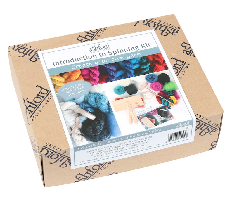 May include: A cardboard box with the text "Introduction to Spinning Kit" and "Create your own yarn". The box contains a spinning kit with carders, a spindle, and fiber. The kit is from Ashford Wheels & Looms.