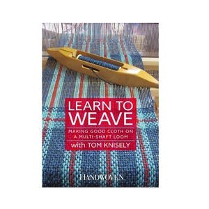 May include: A wooden shuttle with blue thread rests on a woven fabric with red and blue stripes. The image features a book cover with the title "Learn to Weave" and the subtitle "Making Good Cloth on a Multi-Shaft Loom with Tom Knisely."