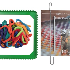May include: A green plastic loom with colorful yarn in the center. A metal hook and a booklet titled "Flotholder Design Ideas" by Harrisville Designs are also included.