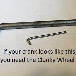 May include: A close-up of a metal crank arm and a small metal hook. The text "If your crank looks like this, you need the Clunky Wheel Kit" is visible below the image.
